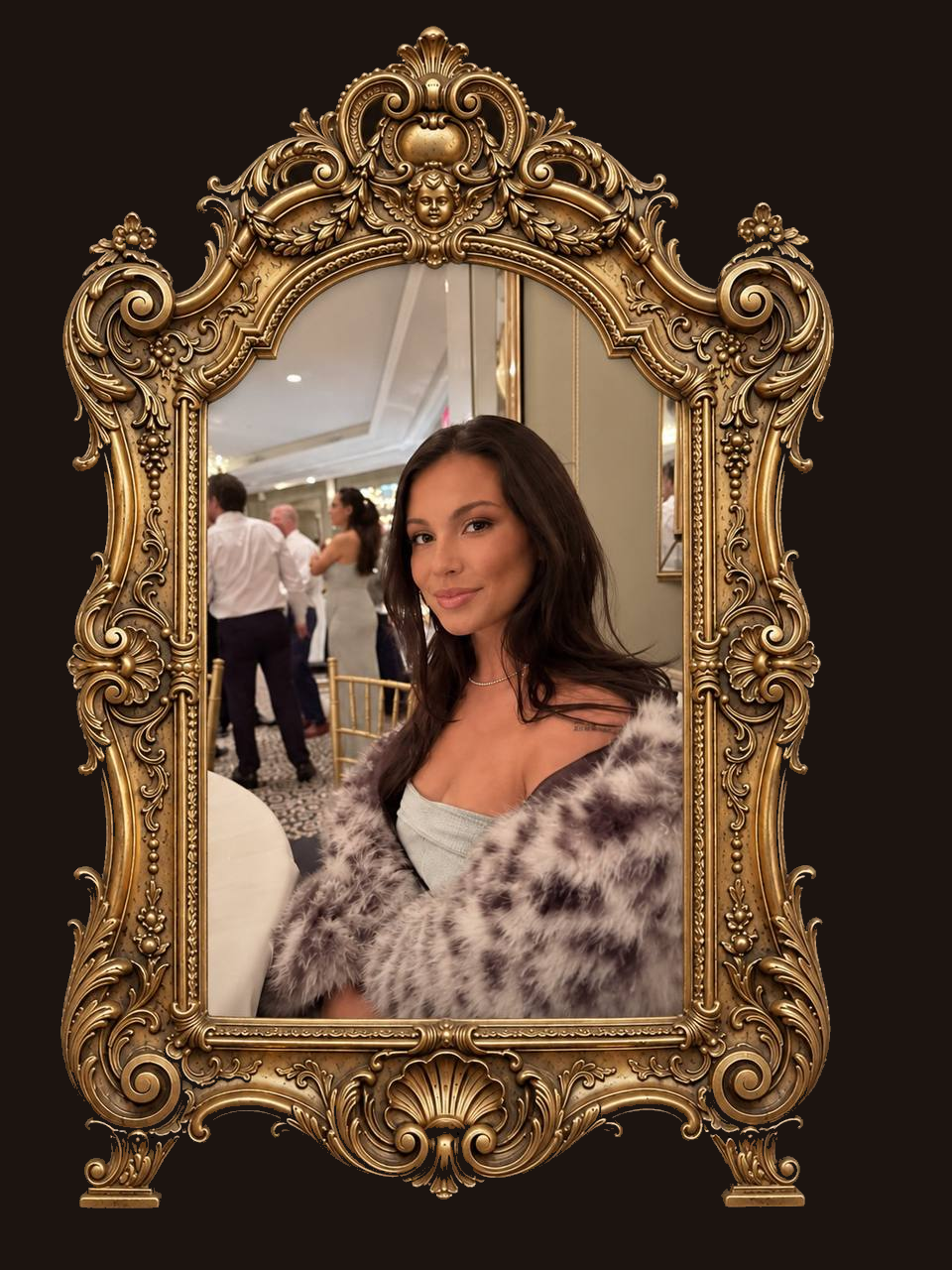 Ali Sage framed in an ornate gold mirror